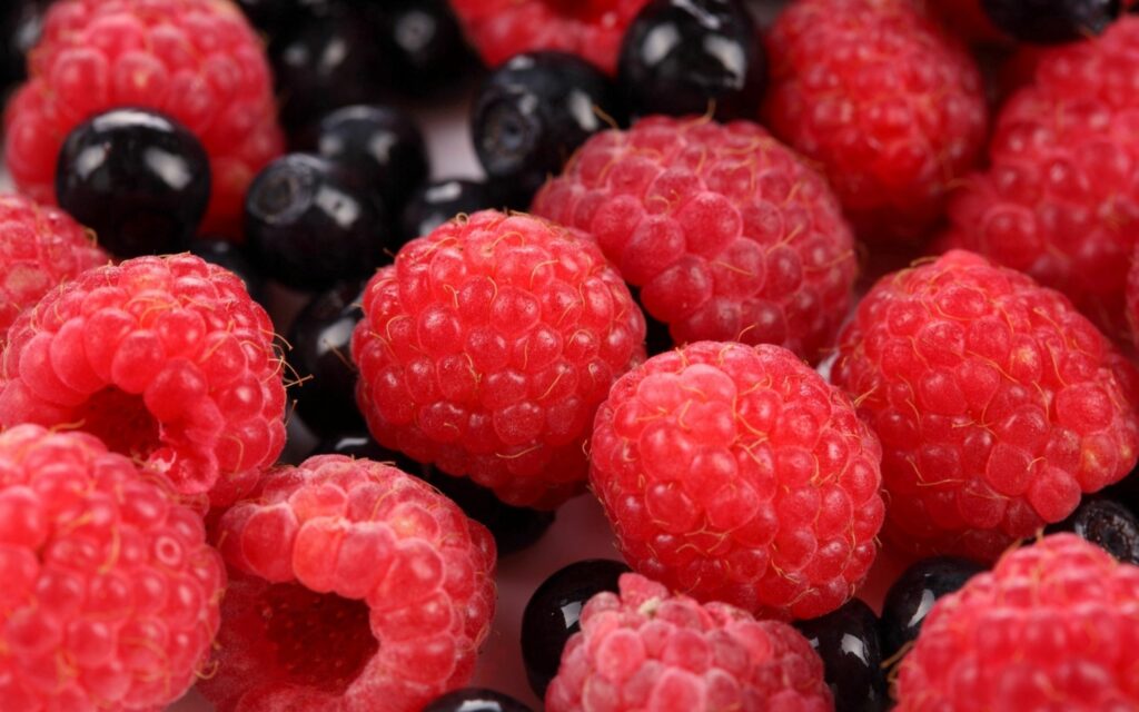 Vibrant Wallpaper of Fresh Raspberries and Blueberries Background