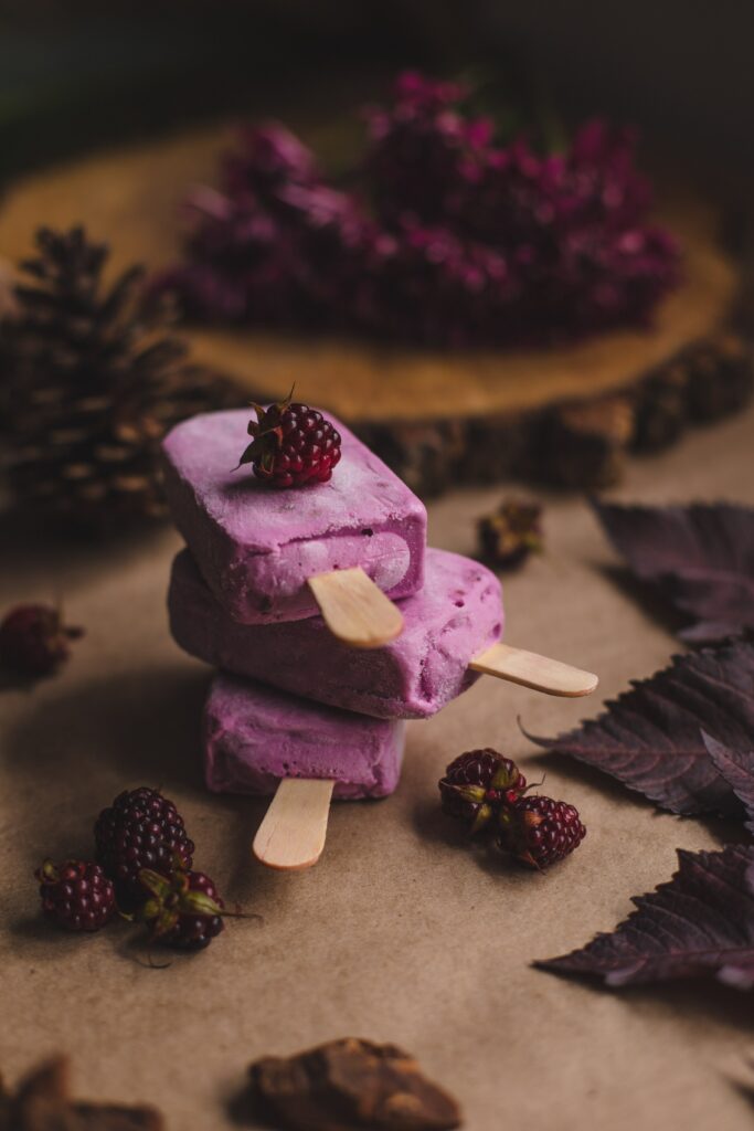 Vibrant Raspberry Ice Cream Popsicles Wallpaper with Fresh Berries