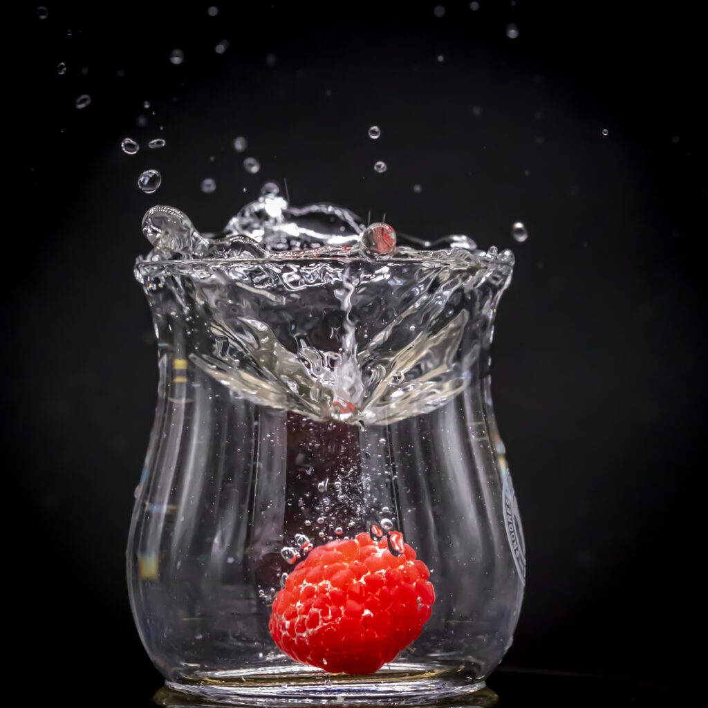 Vibrant Raspberry Splashing in Water - Refreshing Wallpaper Background