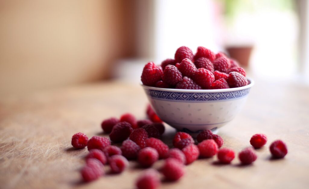 Vibrant Raspberry Wallpaper: Fresh Berries on Wooden Surface Background