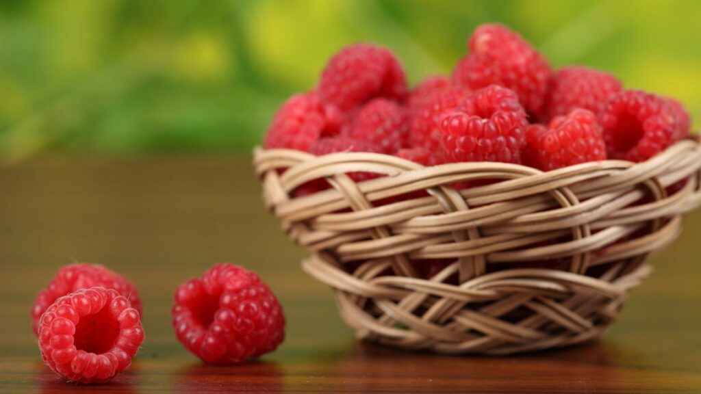 Vibrant Raspberry Wallpaper: Fresh Berries with Green Background