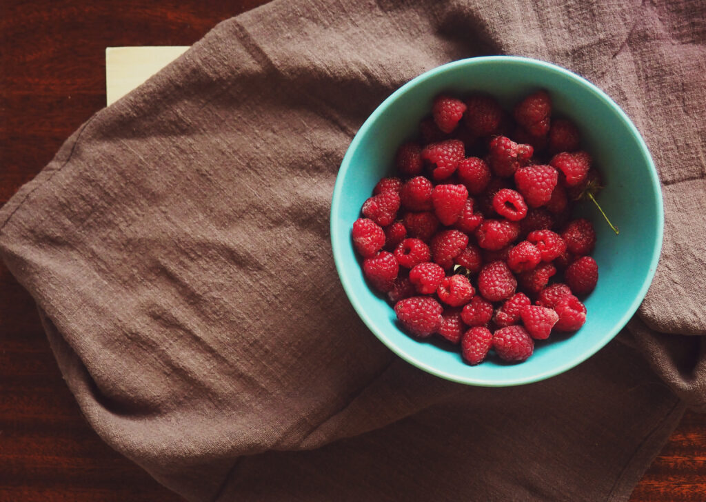 Rustic Wallpaper: Bowl of Fresh Raspberries on Brown Cloth
