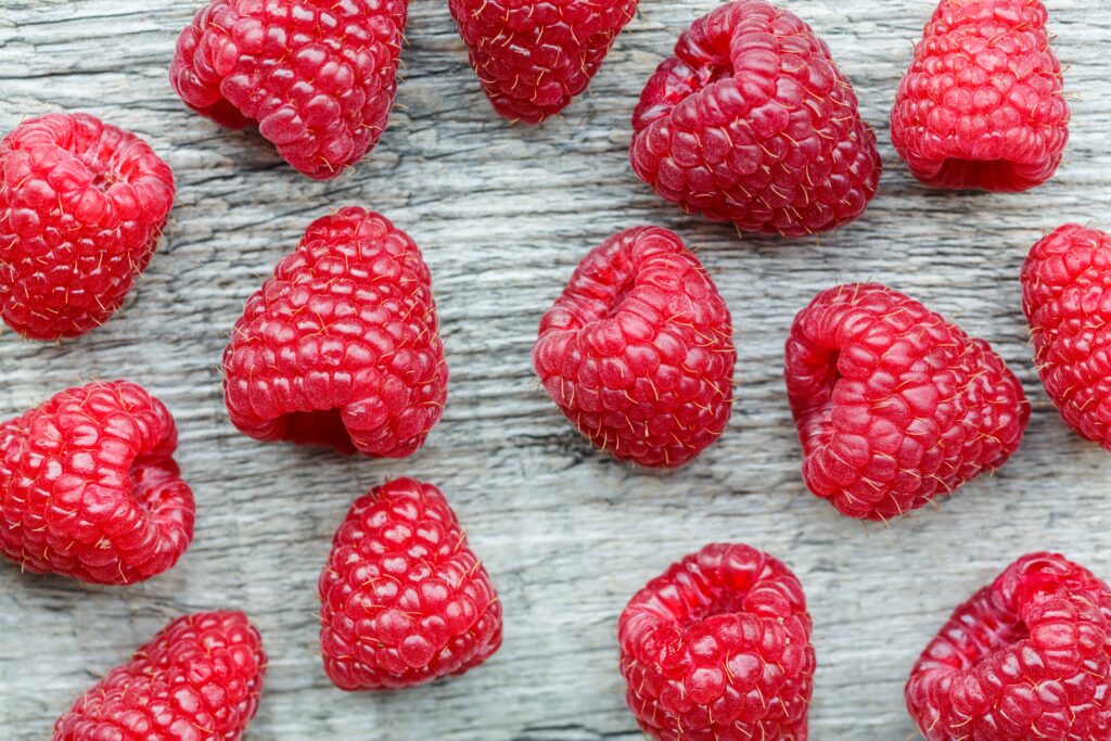 Vibrant Raspberry Wallpaper on Rustic Wood: Rich Red Texture