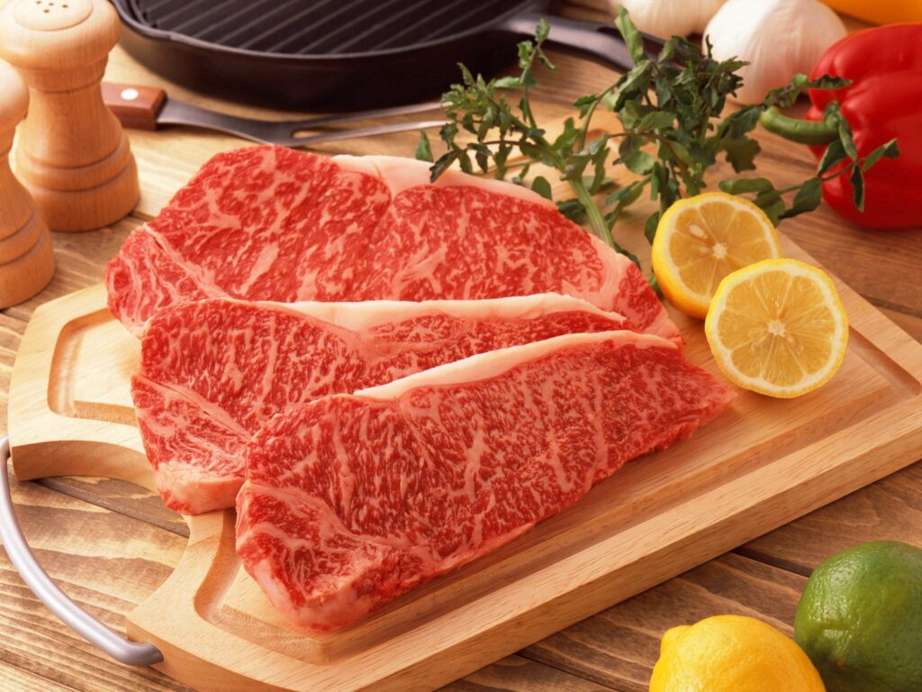 Vibrant Raw Marbled Meat Display with Fresh Citrus & Spices Wallpaper