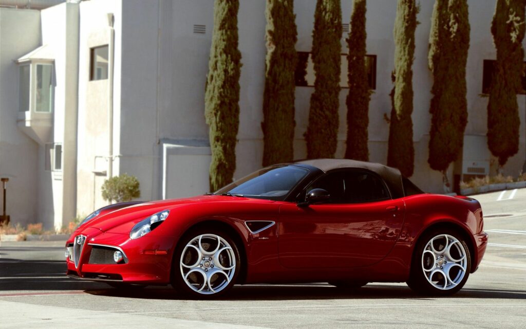 Vibrant Red Alfa Romeo Convertible Wallpaper Against Elegant Background