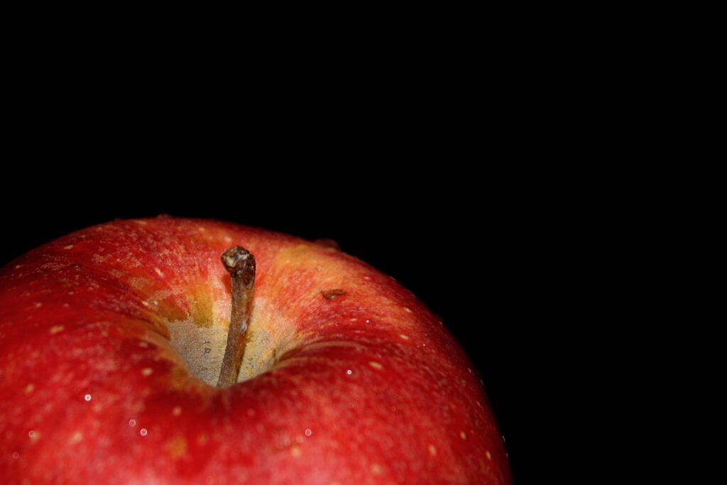 Vibrant Red Apple Close-Up with Water Droplets on Dark Background Wallpaper