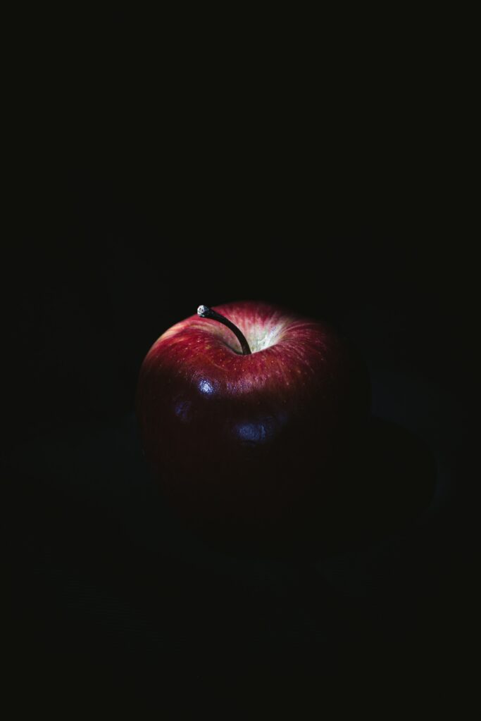 Vibrant Red Apple Wallpaper: Glossy Texture on Dark Background