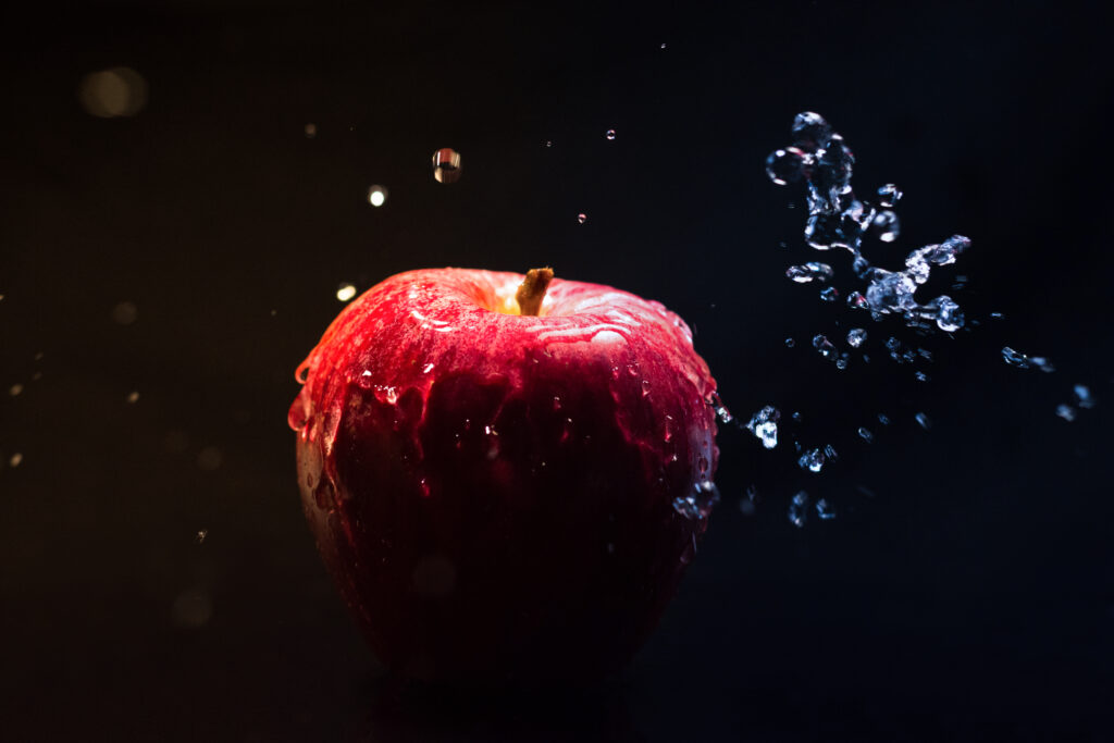 Vibrant Red Apple with Dynamic Water Splashes - Dramatic Wallpaper