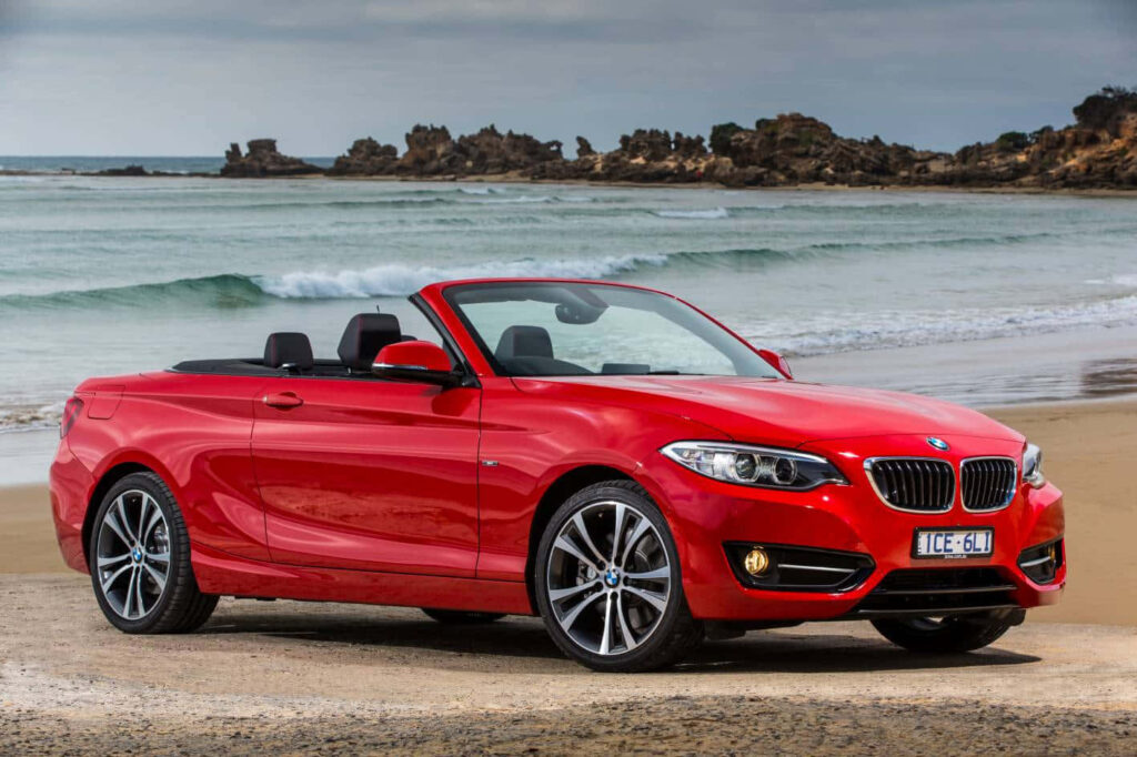 Vibrant BMW 2-Series Convertible on Sandy Beach - Stunning Wallpaper