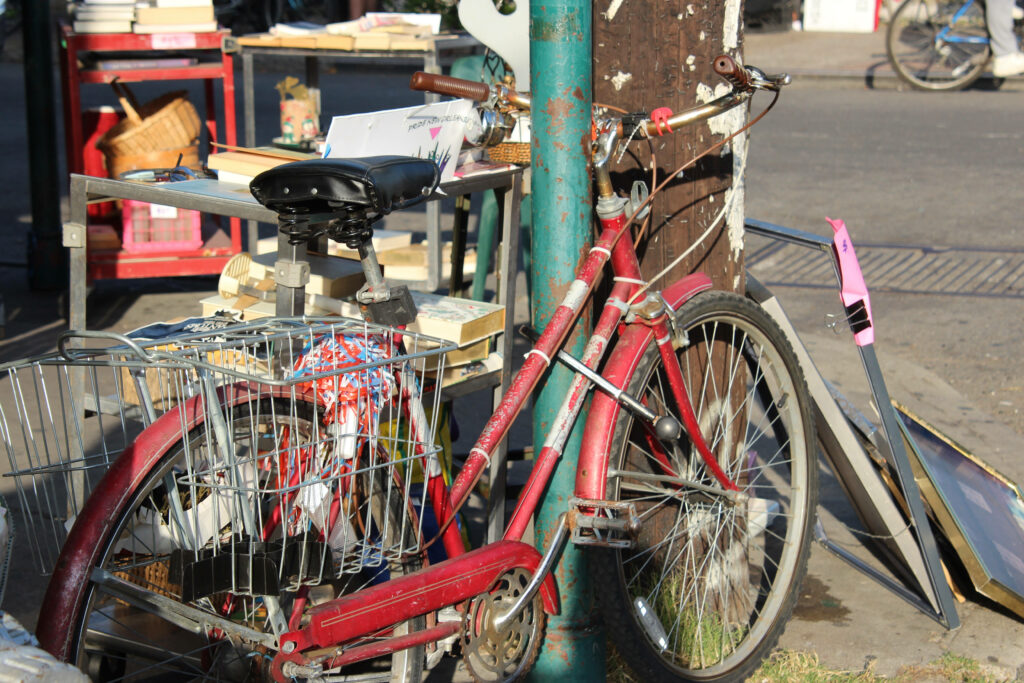Vibrant Red Bike Urban Wallpaper | Rustic City Street Background