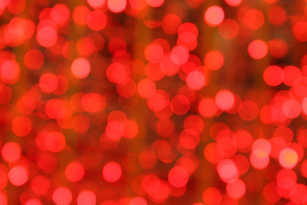 Vibrant red bokeh light wallpaper with soft circular glows perfect for festive backgrounds