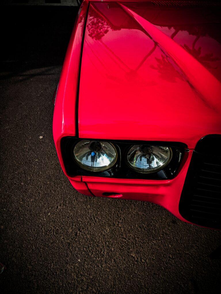Vibrant Red Car Wallpaper: Sleek Design & Gleaming Headlights