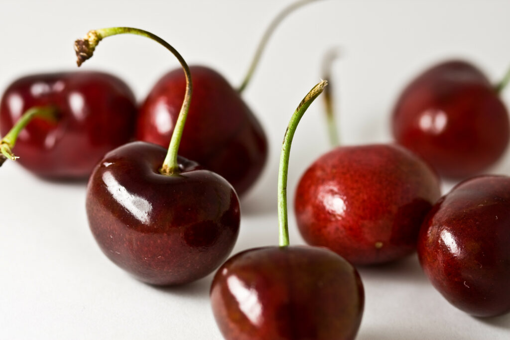 Vibrant Red Cherries Macro Shot - Glossy Texture Wallpaper Background