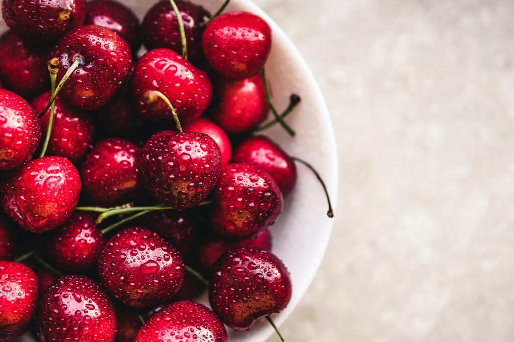 Vibrant Red Cherries with Water Droplets - Fresh Wallpaper Background