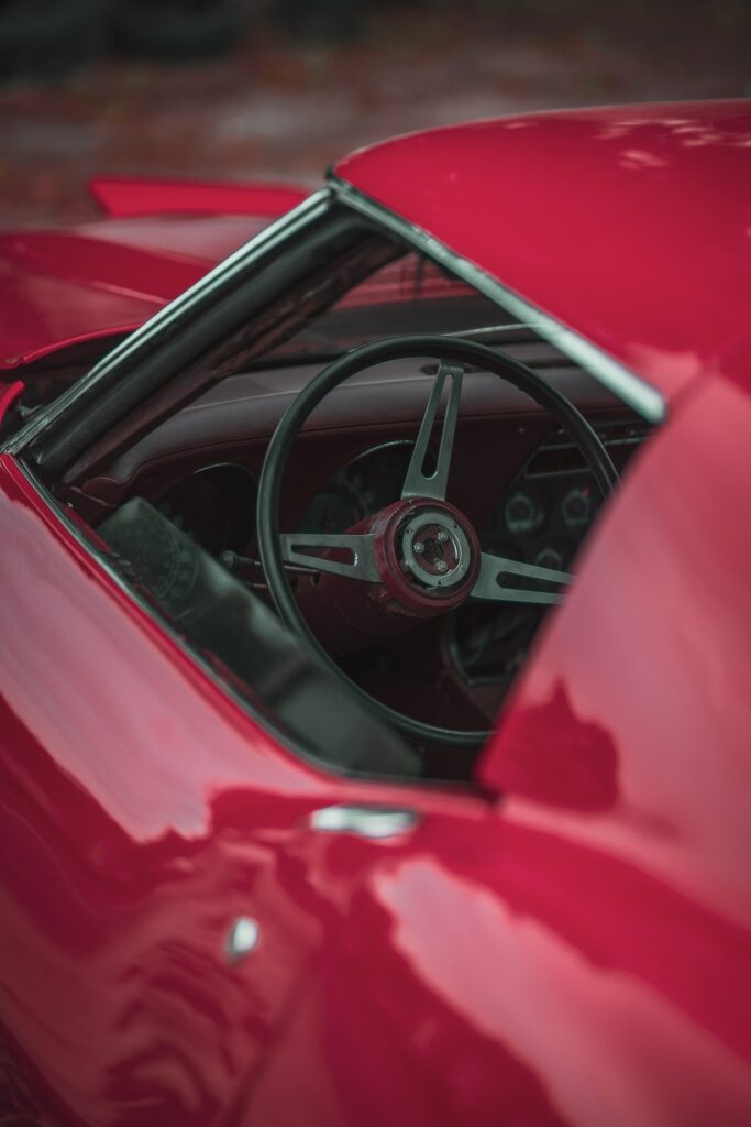 Classic Red Chevrolet Corvette Wallpaper: Sleek Design & Iconic Elegance
