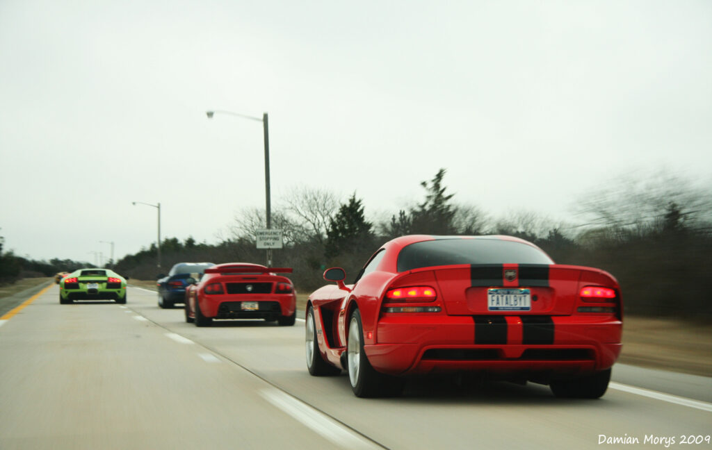 Vibrant Red Dodge Muscle Car: Dynamic Highway Wallpaper