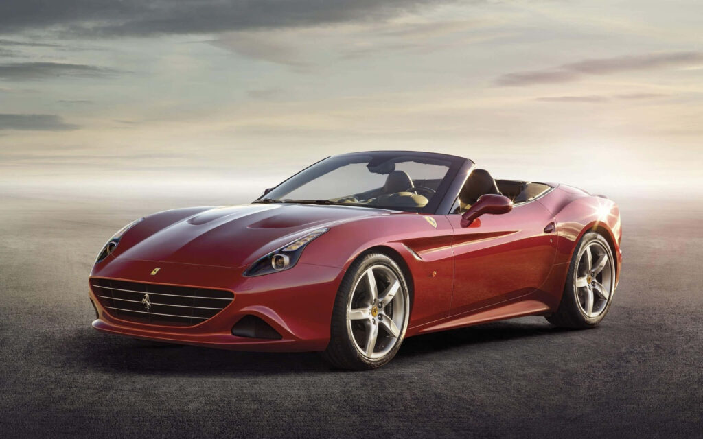 Exquisite Performance: The Enchanting Ferrari California T in Radiant Red Embracing Luxury amidst a Captivating Sunset Scenery Wallpaper