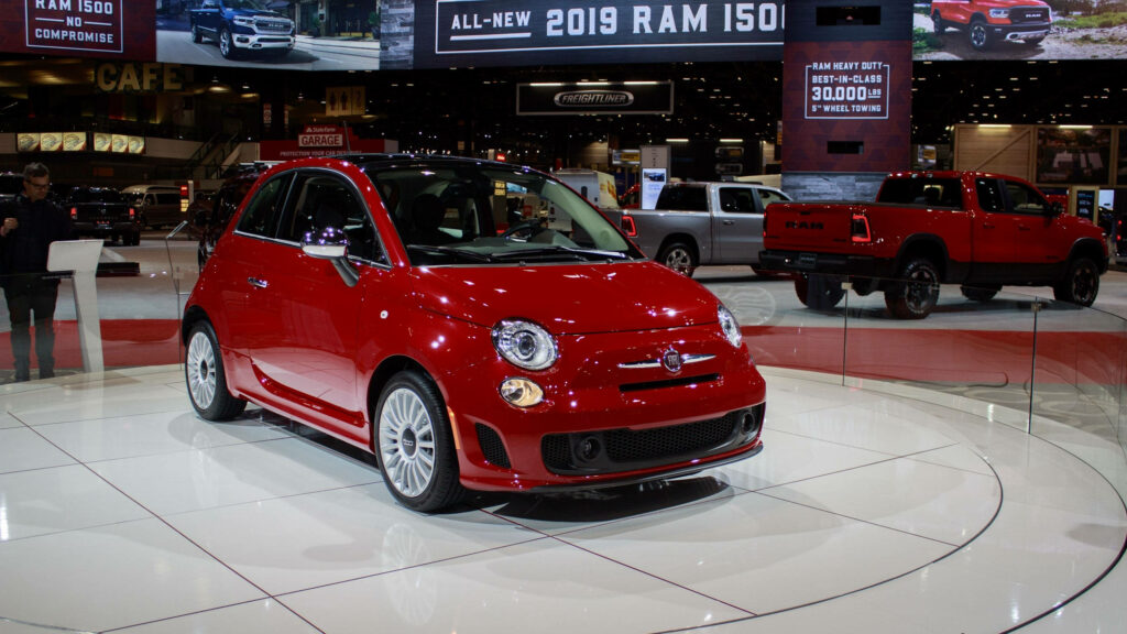 Vibrant Red Fiat 500 Abarth Wallpaper in Modern Showroom Setting
