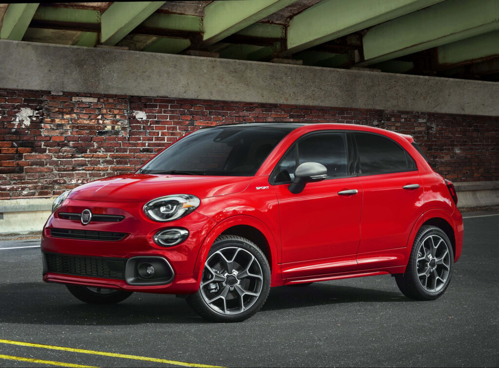Vibrant Red Fiat Crossover: Modern Design Against Rustic Wall Wallpaper
