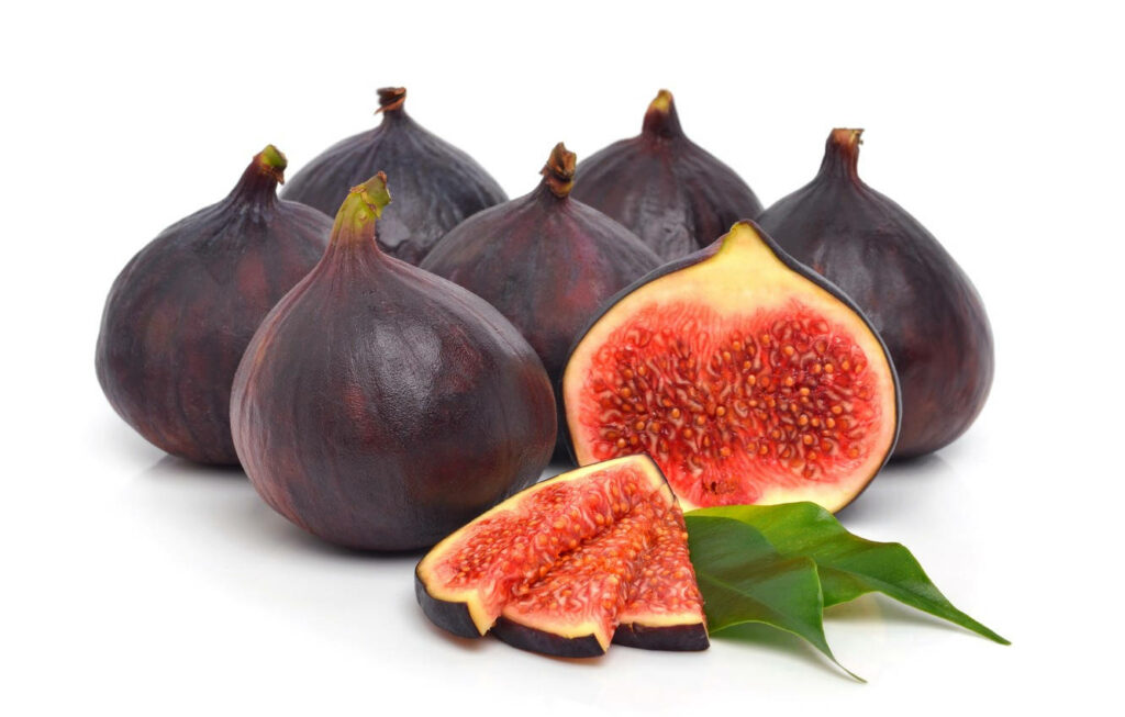 Vibrant Red Fig Wallpaper: Fresh Slices & Lush Green Leaves