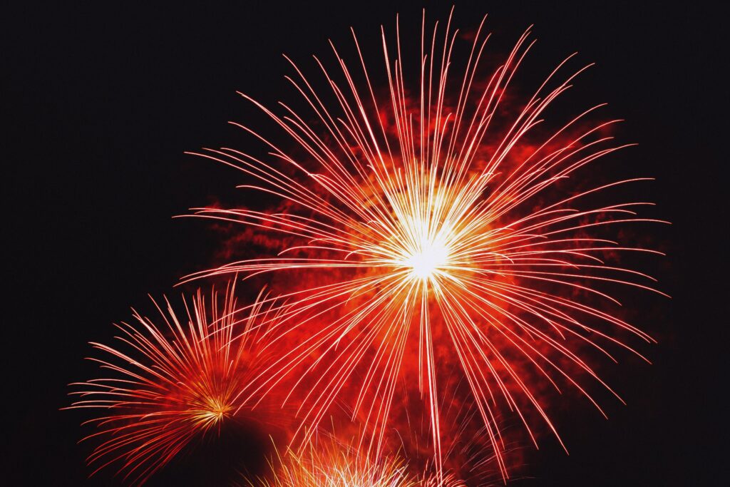 Vibrant Red Fireworks Wallpaper: Stunning Night Sky Celebration