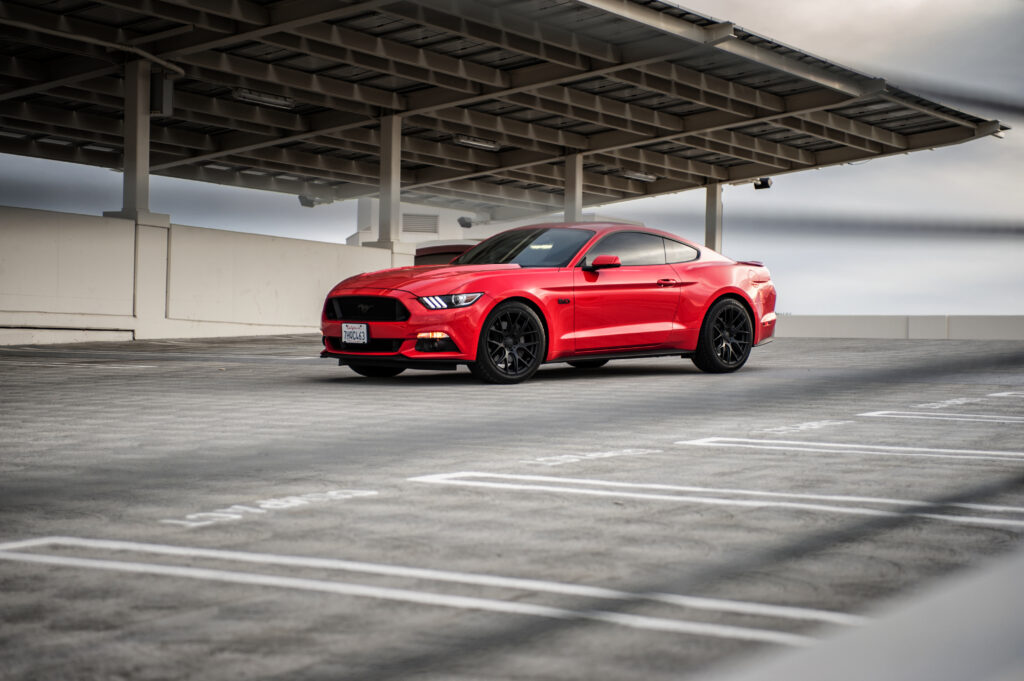 Vibrant Red Ford Mustang Wallpaper: Stunning Front View on Asphalt