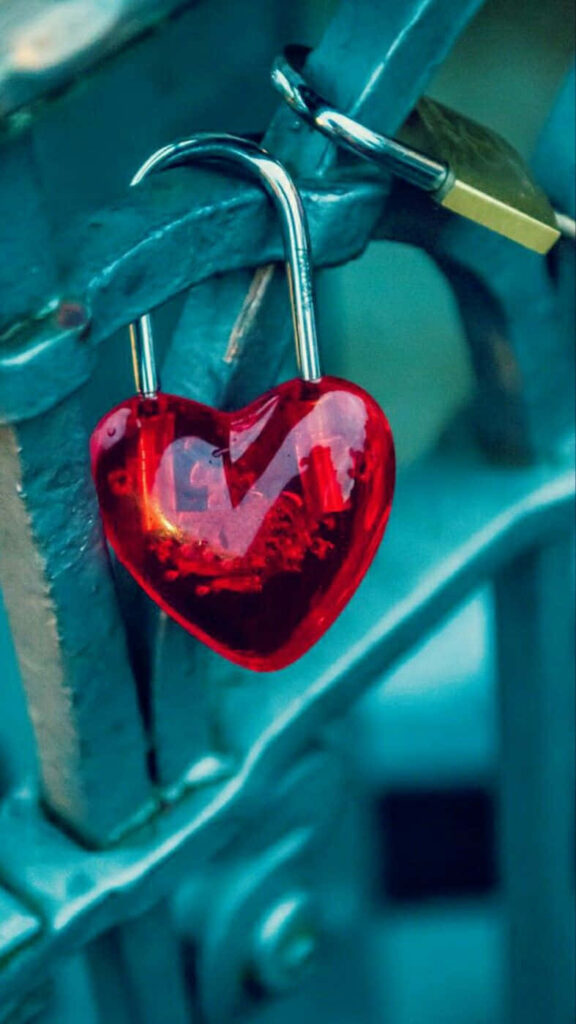 Vibrant Red Heart-Shaped Love Lock on Teal Railing Wallpaper