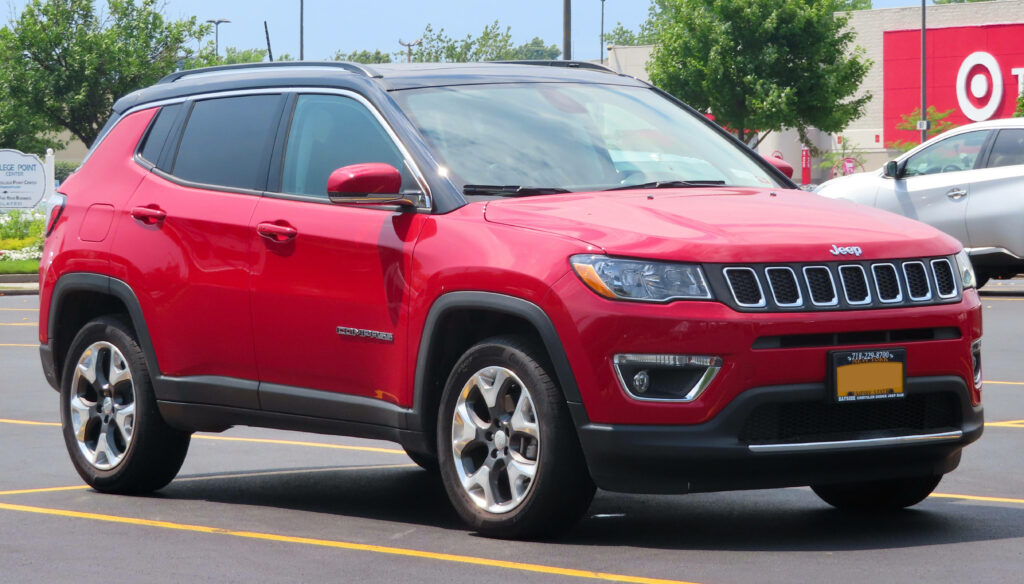 Red Jeep Compass parked outdoors showing sleek modern design and sporty vibrant style Wallpaper