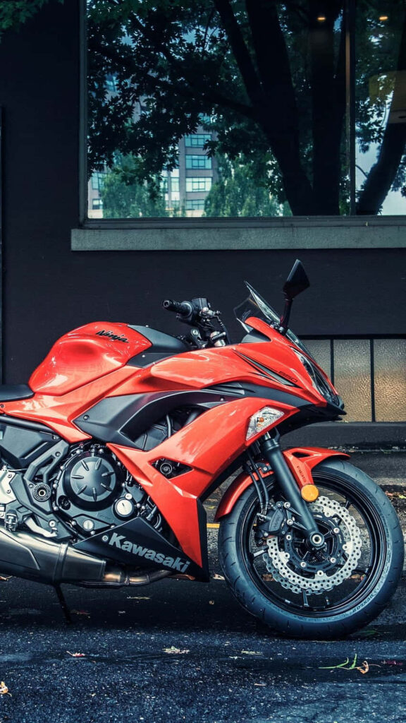 Vibrant Red Kawasaki Motorcycle Wallpaper: Urban Backdrop & Details