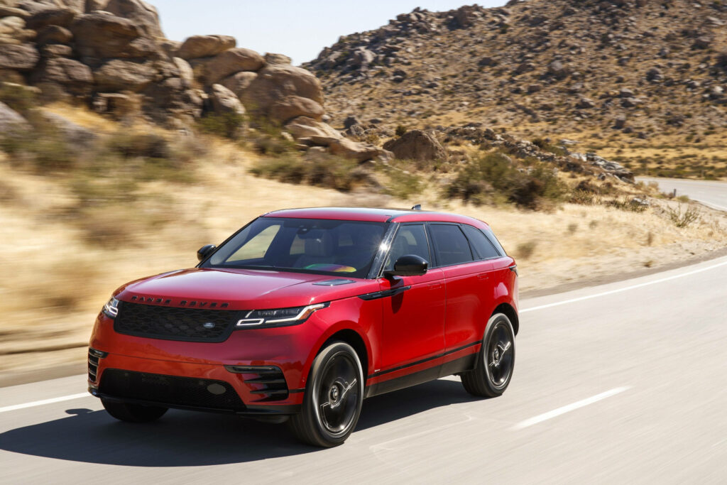 Vibrant Red Land Rover SUV in Scenic Arid Landscape Wallpaper