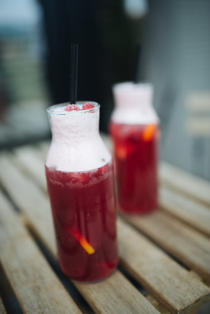 Vibrant Red Lemonade Cocktails Wallpaper with Cream & Fresh Garnishes