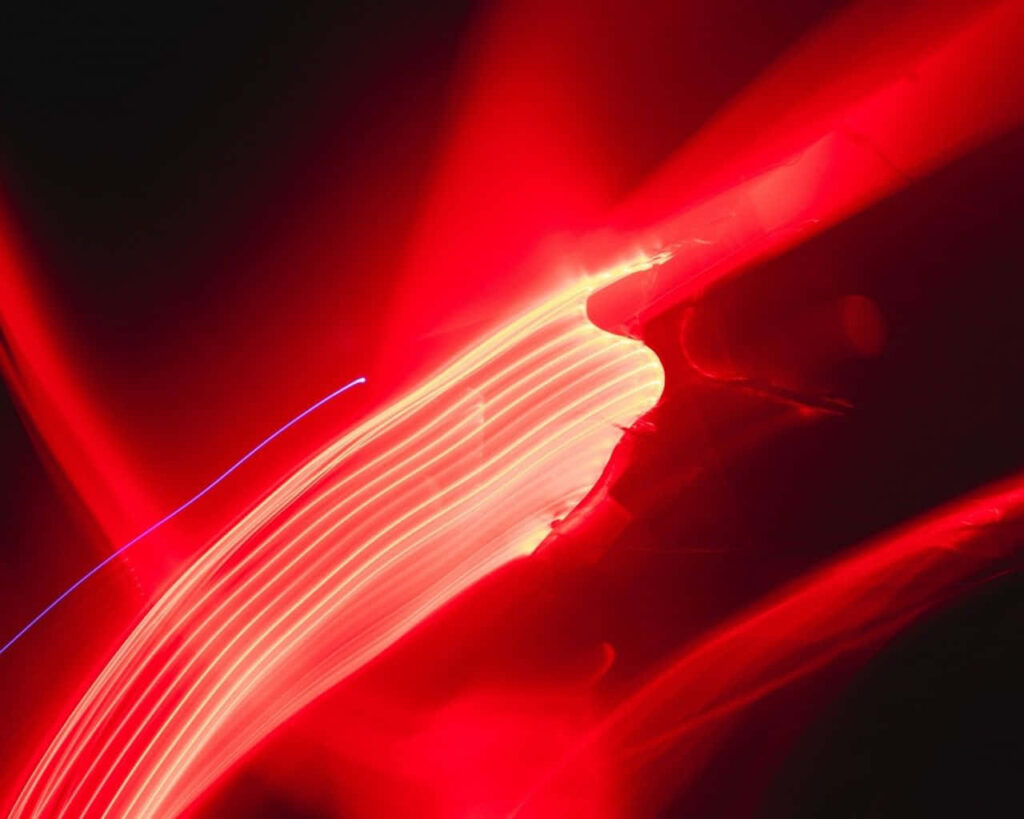 Vibrant Red Light Abstract Wallpaper: Energetic Dark Background