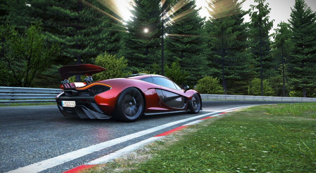 Vibrant red McLaren P1 4K wallpaper on scenic racetrack with lush forest and sunlight rays