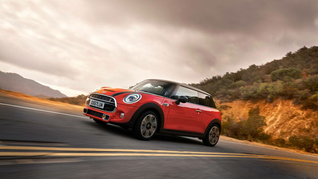 Vibrant Red Mini Cooper Wallpaper: Scenic Road Adventure Background