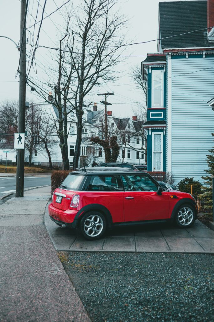Vibrant Red Mini Cooper in Cozy Residential Background Wallpaper