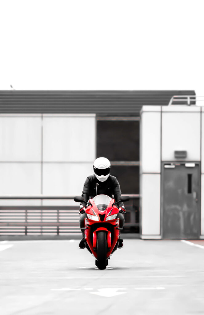 Vibrant Red Motorcycle Wallpaper in Modern Urban Setting