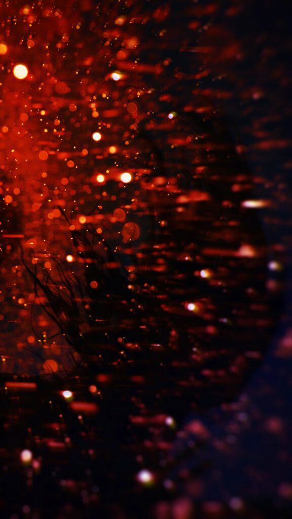 Vibrant Red and Orange Blurred Background Wallpaper with Sparkling Lights