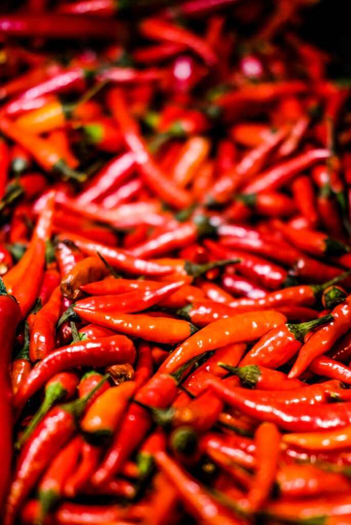 Glossy Red Peppers Wallpaper: Vibrant Close-Up Background