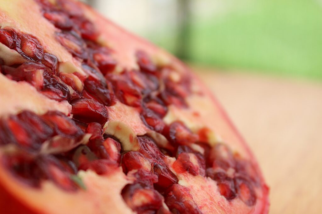 Vibrant Red Pomegranate Seeds: Juicy Texture Wallpaper Background