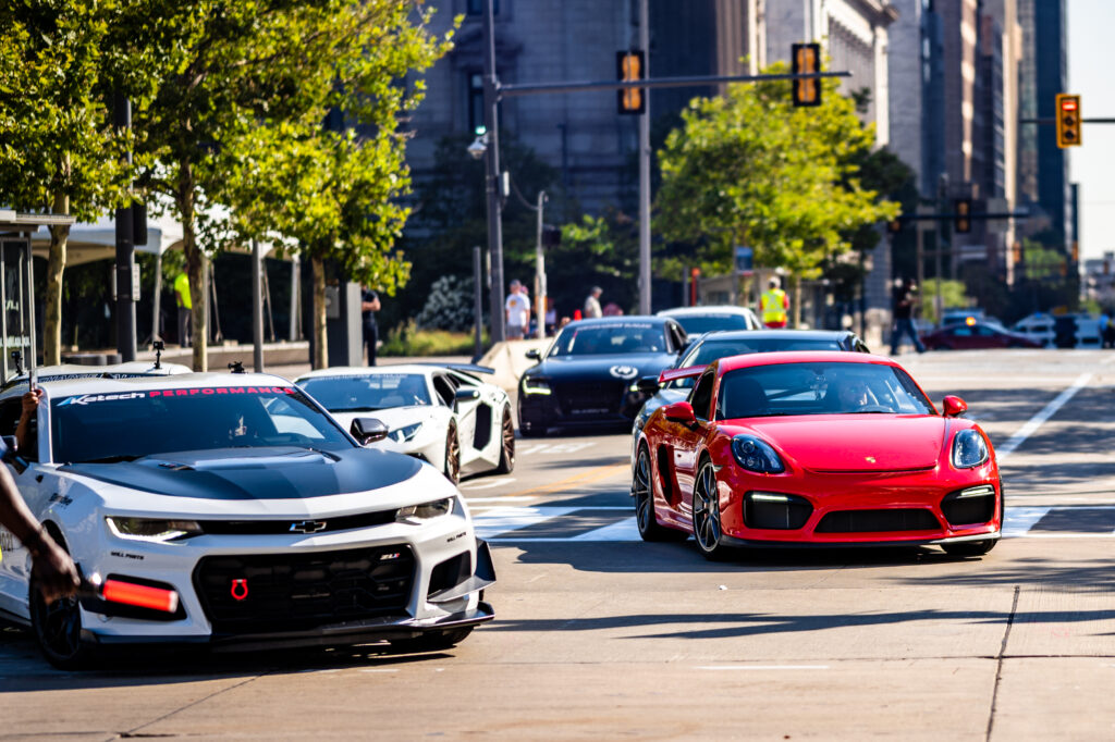 Vibrant 6048x4026 Wallpaper: Red Porsche on Busy Urban Road