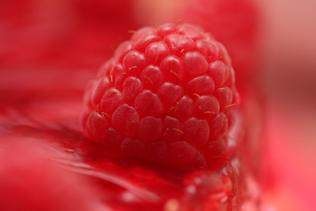 Vibrant Red Raspberry Macro: Textured Wallpaper Background