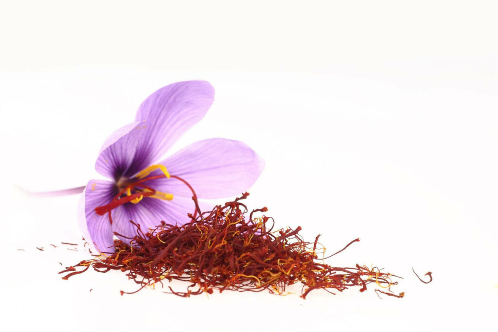 Vibrant Red Saffron Threads & Purple Flower on White Background Wallpaper