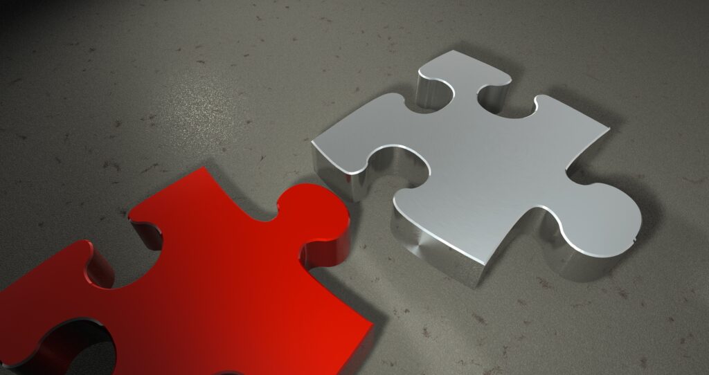 Vibrant Red & Silver 3D Puzzle Pieces on Textured Gray Wallpaper