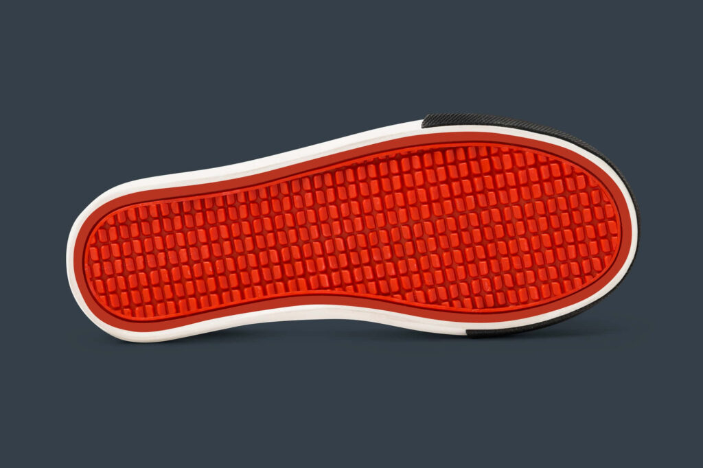 Vibrant Red Sole Rubber Shoe Tread Pattern on Dark Background Wallpaper