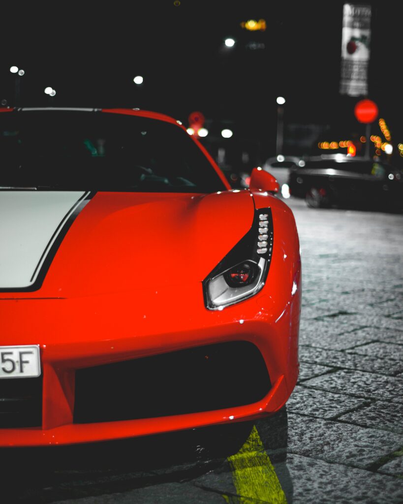 Dynamic Red Sports Car Wallpaper: Bold Design Night City View