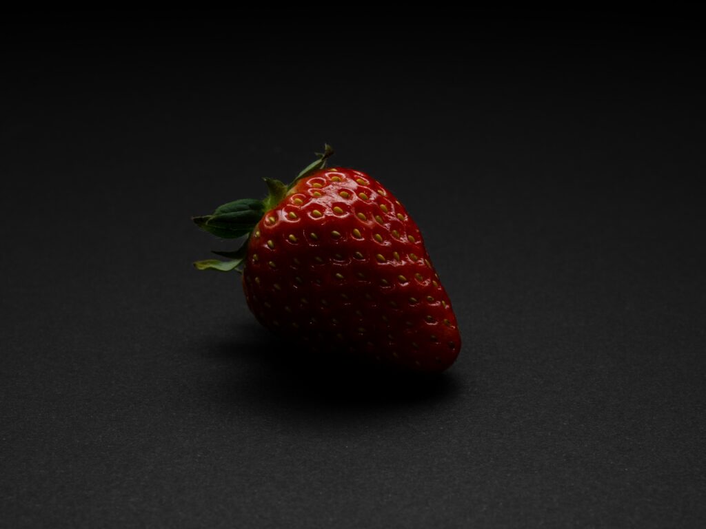 Vibrant Red Strawberry Wallpaper: Fresh, Juicy Texture on Dark Background