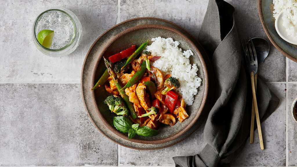 Vibrant Red Thai Curry Chicken Stir Fry with Rice - Rustic Wallpaper