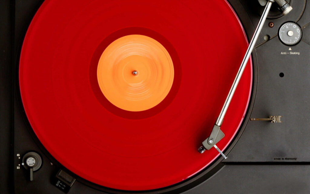Vibrant Red Vinyl Record on Classic Turntable - Retro Wallpaper