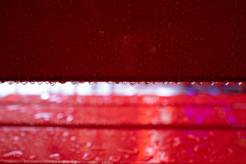 Vibrant Red Wallpaper: Macro Water Droplets on Glossy Surface