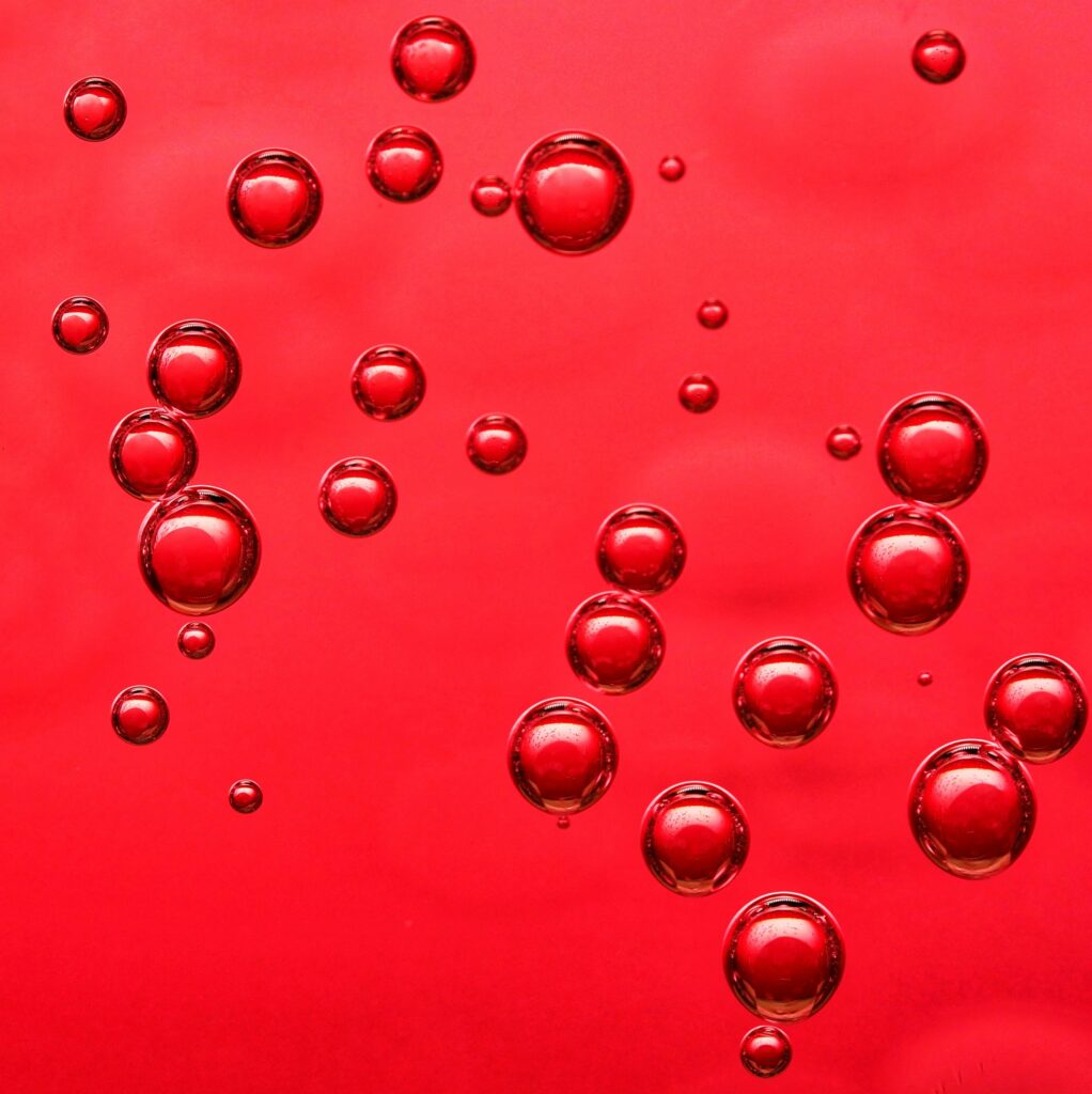 Vibrant Red Wallpaper with Liquid-Like Bubbles - Macro Background